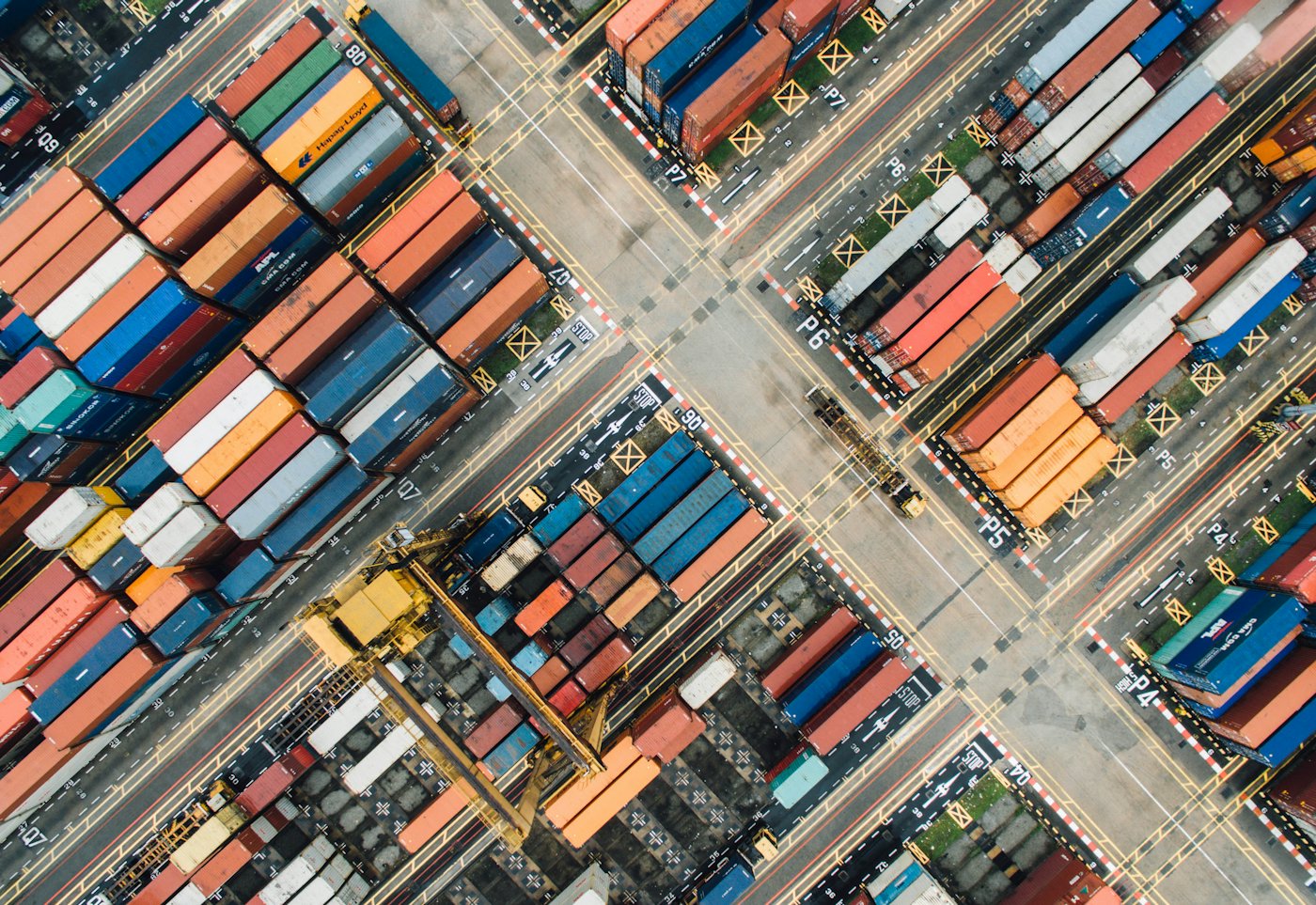Aerial view of stacked shipping containers in a port yard